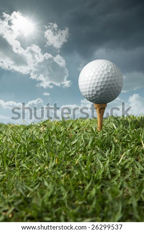 golf ball on tee with sunny day