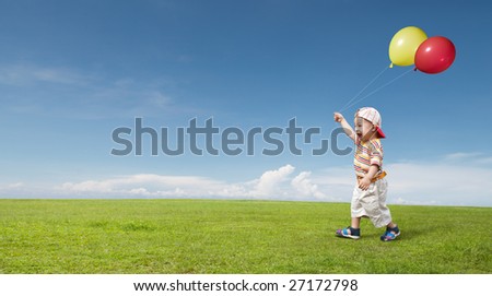 kid holding two balloon and enjoying himself