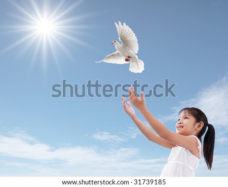 cheerful young girl releasing a white dove
