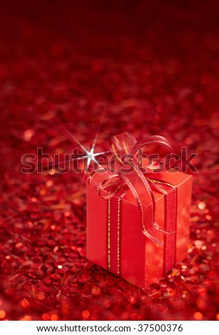 gift box tied with ribbon on red background