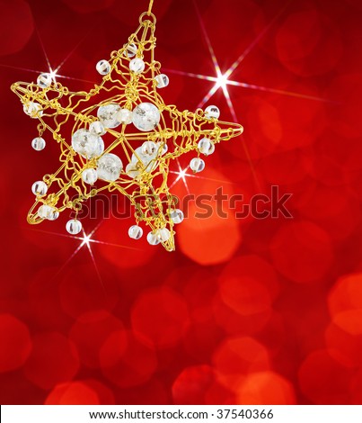 star shape christmas ornament on red lights background