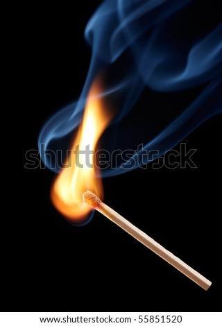 matchstick with flame on black background