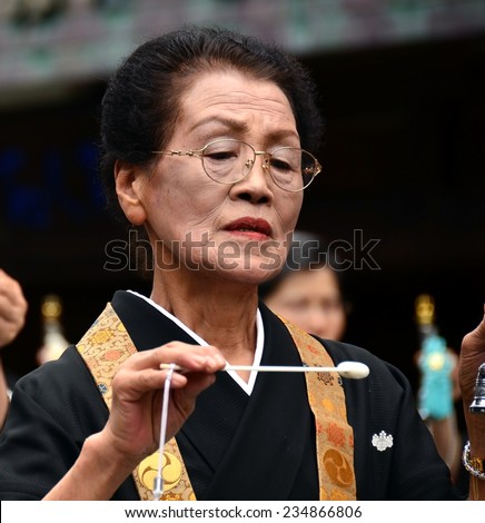 Koya, Japan - June 14, 2011: Woman in formal buddhist attire during Aoba festival, an annual event celebrating the birthday of Kobo Daishi (Kukai), one of Japan\'s most renowned Buddhist saints