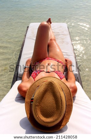 Young beautiful woman enjoying her time and resting close to the sea in Yandup lodge\'s private beach, Yandup Island, San Blas, Panama