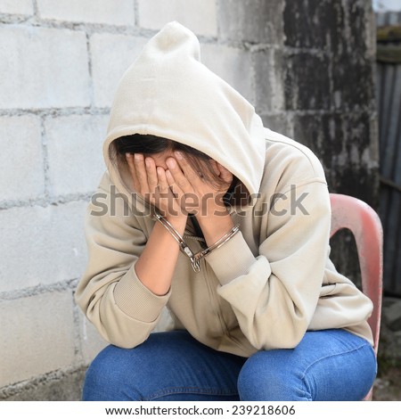 Woman in Handcuffs Hide her Face