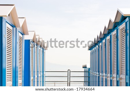 Rows of  tipical italian  blue and white wooden beach huts. Photo taken at Arenzano, Liguria, Costa Azzurra, Italy.