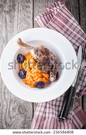 Roasted duck leg with mashed carrot and dried prunes
