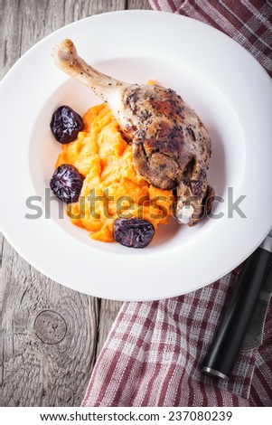 Roasted duck leg with mashed carrot and dried prunes