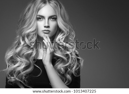 Female hairstyle long and cuerly black and white portrait over gray background