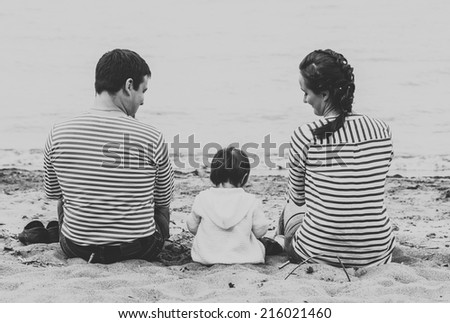 family on the beach black and white