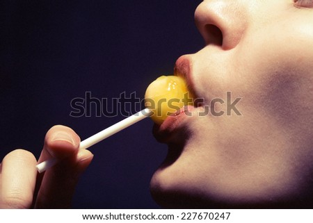woman lips sucking a candy