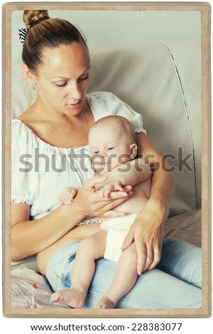 mother with child baby infant at home in room on bed vintage card
