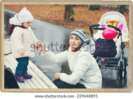 Family nature Mother with Child Baby in Park in Autumn in Same Clothes