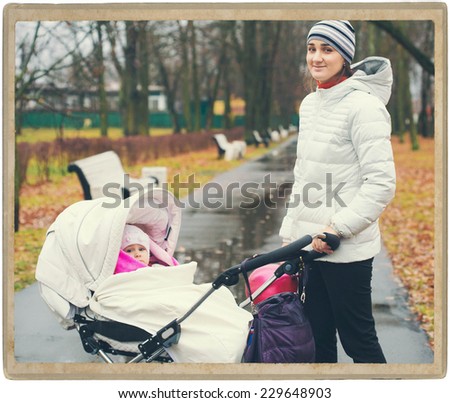 Family nature Mother with Child Baby in Park in Autumn in Same Clothes