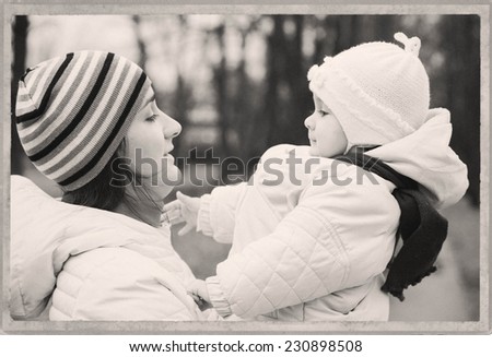Family Mother with Child in park walking in same clothes black and white