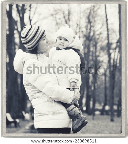 Family Mother with Child in park walking in same clothes black and white