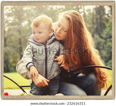 Family  parent mother with child in park in autumn walking