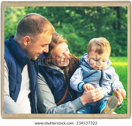 Family father and mother with child in park walking in same clothes textile jeans jacket