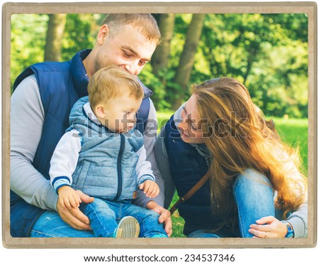 Family father and mother with child in park walking in same clothes textile jeans jacket
