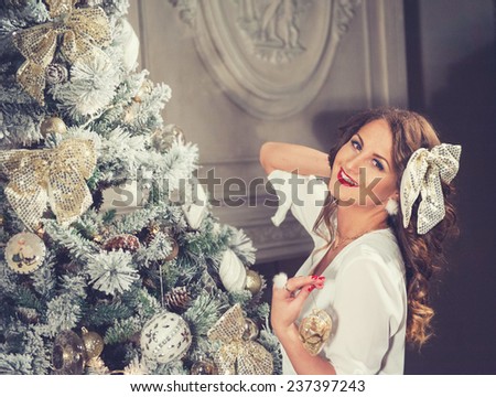 New Year Woman Portrait near Christmas Tree with gift boxes