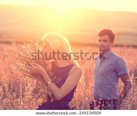 Happy people outdoors beautiful landscape and couple in love with flowers on sunset happy people outdoor