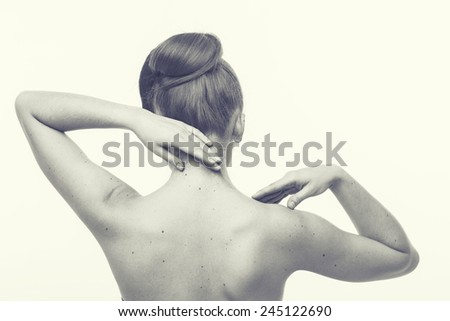 Back ache massage - Woman with backache from behind, naked body.