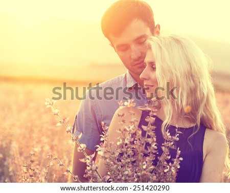 Couple in love happy outdoors summer fields flowers