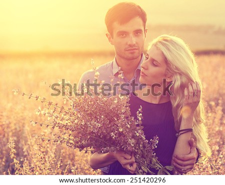 Couple in love happy outdoors summer fields flowers