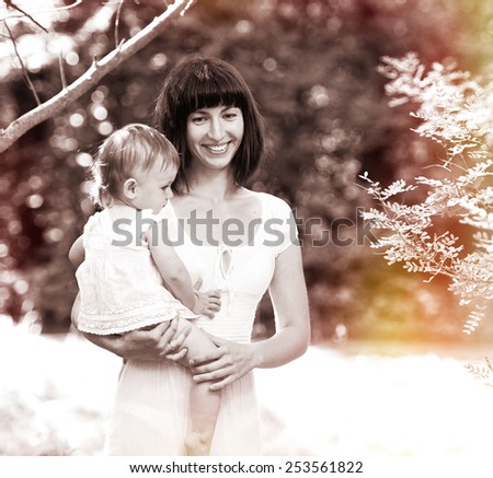 Family happy outdoors black and white vintage mother with child playing