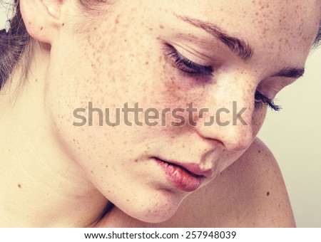 Portrait of fun attractive girl woman with freckles clear skin and beautiful hair hipster