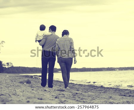 Family on the beach fashion in stripes clothes same vintage black and white