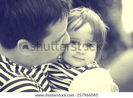 Family with child and father  in same stripes clothes vintage black and white nature