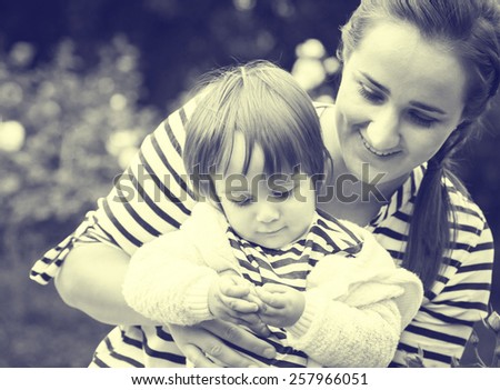 Family with child and mother in same stripes clothes vintage black and white nature