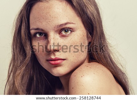 Portrait of fun attractive girl woman with freckles clear skin and beautiful hair hipster