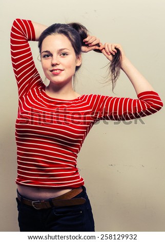 Young woman namaste in fashion stripes clothes hipster casual posing on light background