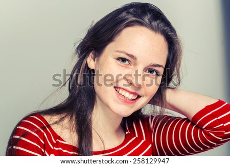 Young woman namaste in fashion stripes clothes hipster casual posing on light background