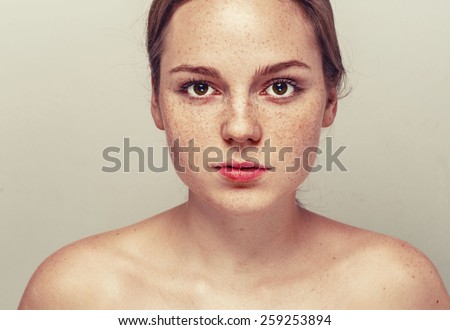 Woman  face freckled young beautiful healthy skin and long hair portrait