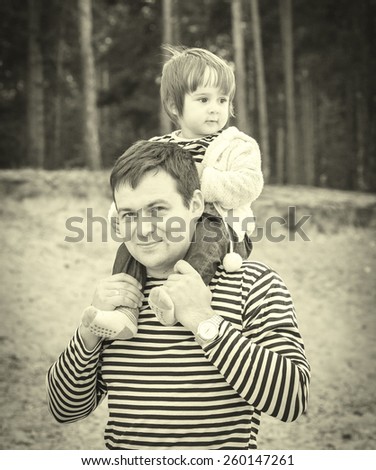 Family with child father in same stripes clothes vintage black and white nature