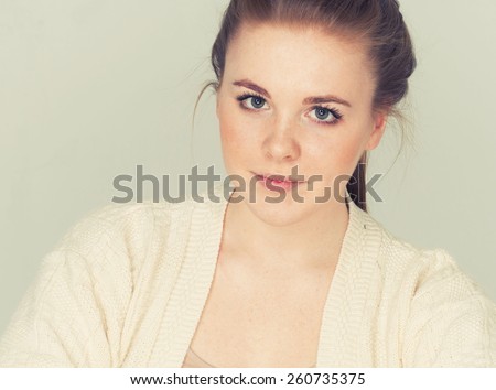 young beautiful woman with freckles portrait studio on light background hipster posing