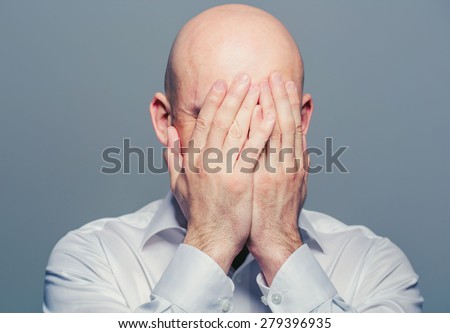 Bald man face closed hands