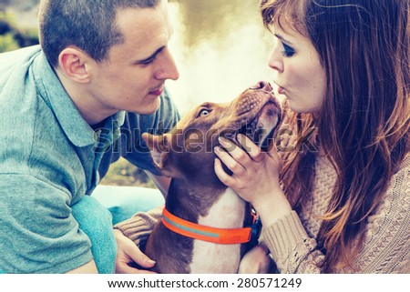 Couple in love with dog nature dog licking man