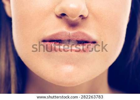 Woman bite lips close up face beautiful
