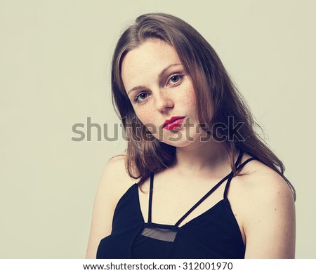 Young woman beautiful portrait with red lips and freckles