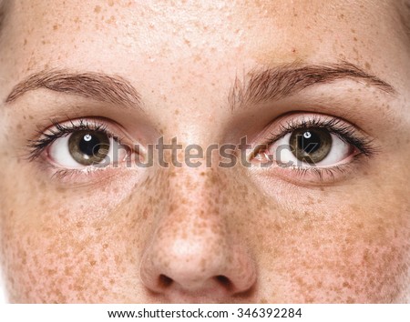 Eyes Young beautiful freckles woman face portrait with healthy skin
