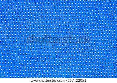 Blue knitting wool with white stitches texture background.