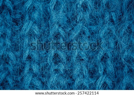Blue knitting wool texture closeup photo background.