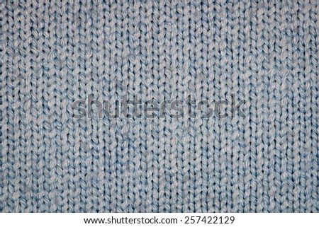 Blue knitting wool texture closeup photo background.