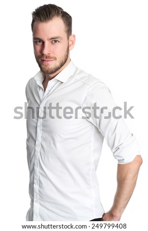 A young attractive man standing against a white background, wearing a white shirt. Feeling great with a smile on his face.
