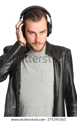 Young attractive DJ wearing headphones and a black leather jacket. White background.