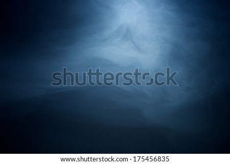 Swirling Hazy Smoke in a Beam of Light on Black Background